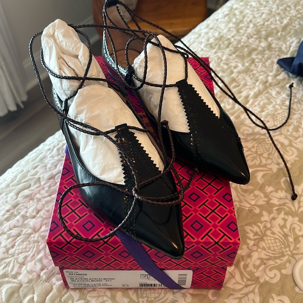 Black Tory Burch lace up flats.